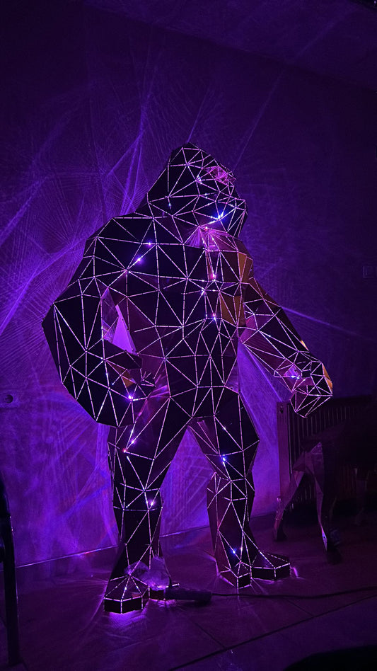 Geometric metal King Kong gorilla sculpture with purple lighting.