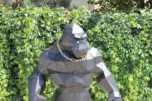 Geometric King Kong metal gorilla sculpture in modern outdoor garden setting