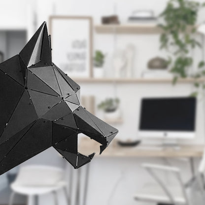 Close-up of a handcrafted black geometric metal wolf head sculpture in a modern interior.