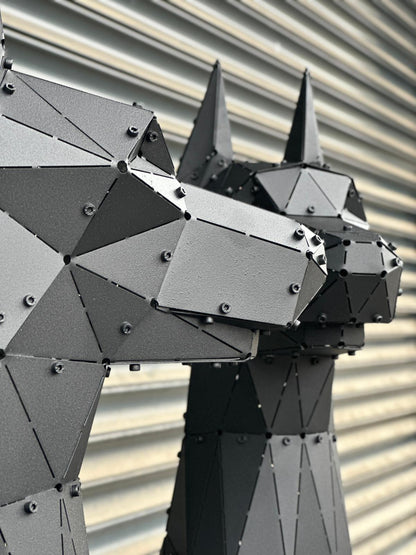 Close-up of a handcrafted geometric black metal Doberman sculpture head with industrial rivets