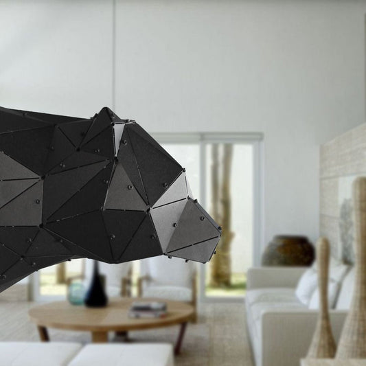 Close-up of a luxury black geometric metal bear head sculpture in a modern interior