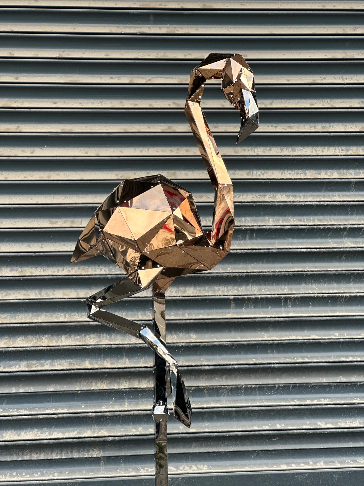Handcrafted geometric metal flamingo sculpture with a polished silver mirror finish
