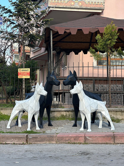 Four low-poly geometric metal dog sculptures in black and white colors.