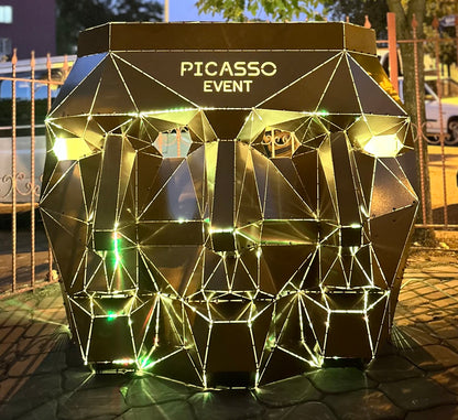 Geometric gold metal face sculpture with integrated lighting and PICASSO EVENT text