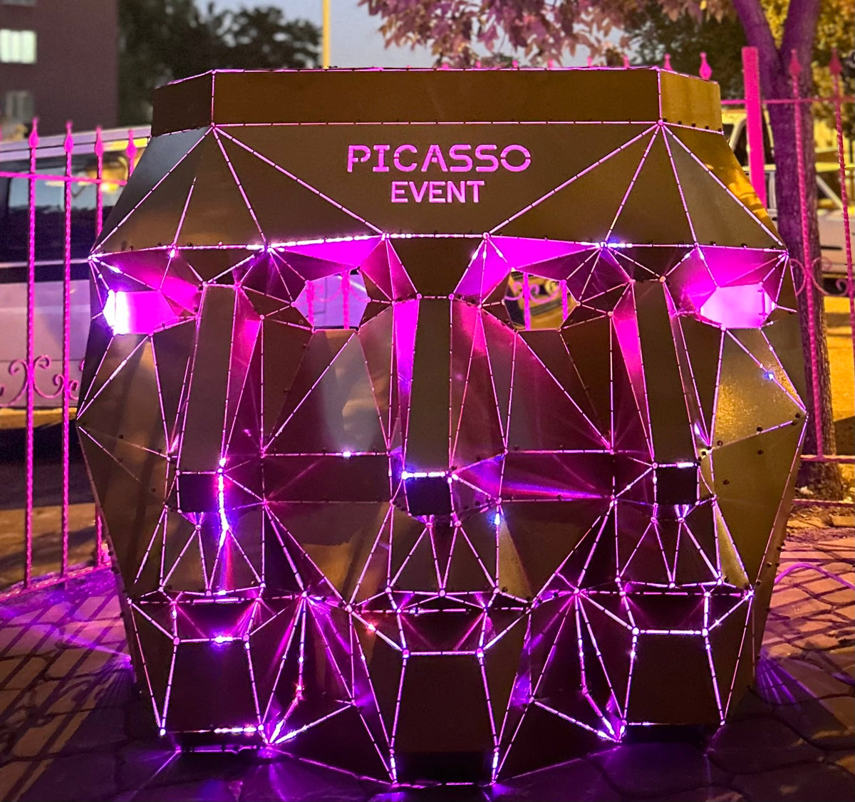 Geometric metal face sculpture with purple LED lights and 'PICASSO EVENT' text