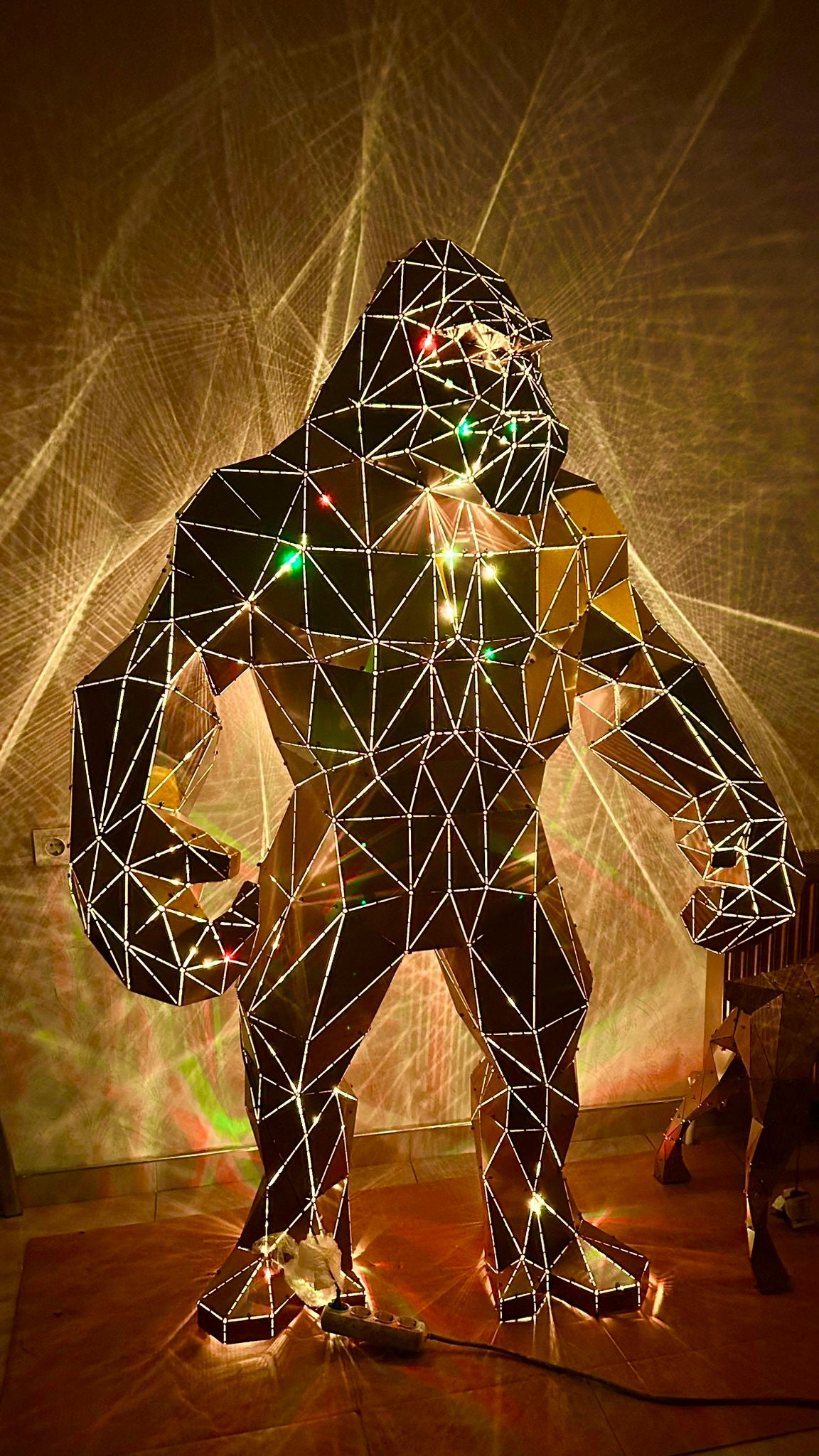 Geometric metal gorilla sculpture with integrated lights and reflective facets