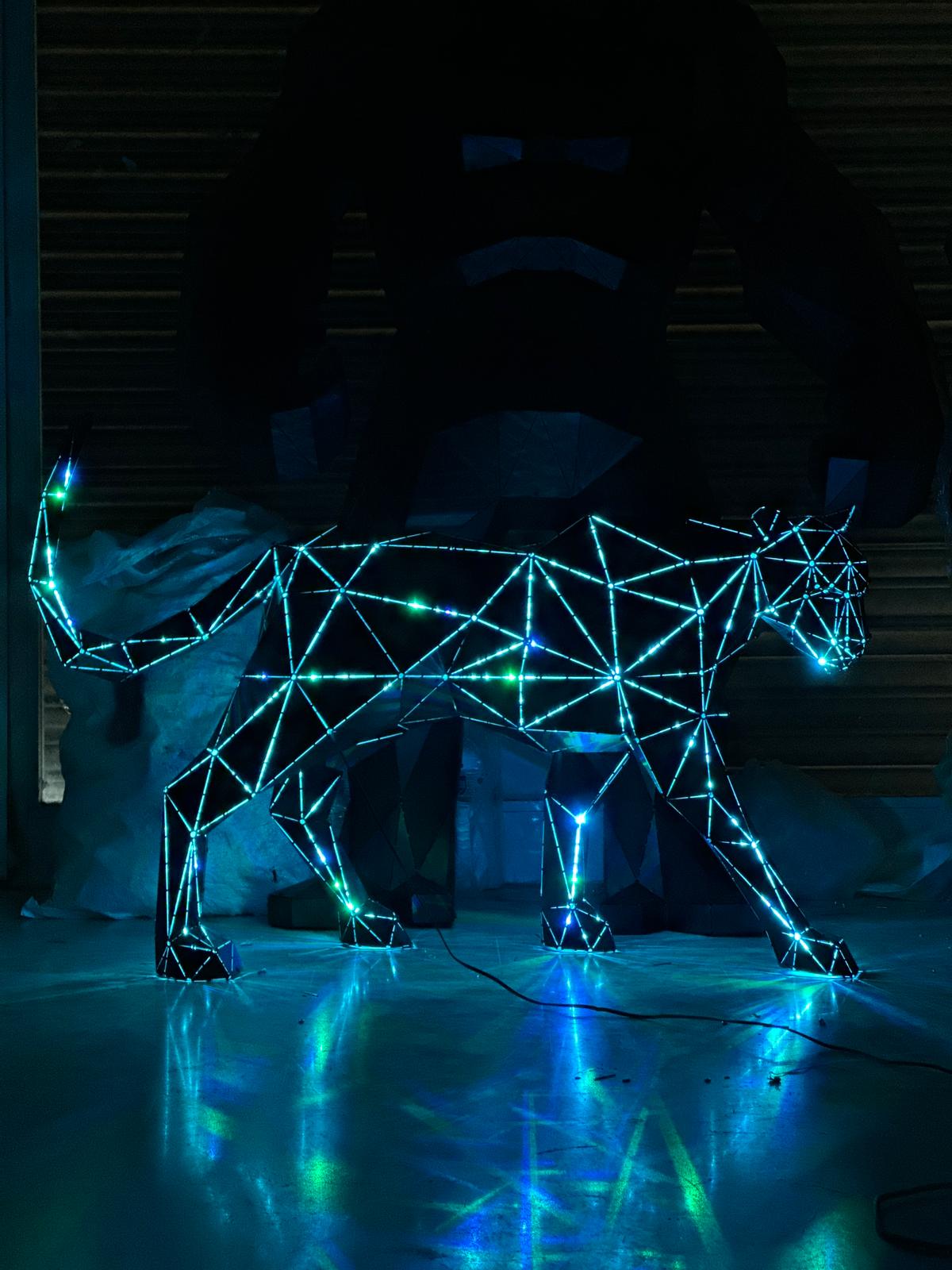 Geometric metal panther sculpture with glowing blue and green LED lights