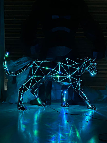 Geometric metal panther sculpture with glowing blue and green LED lights
