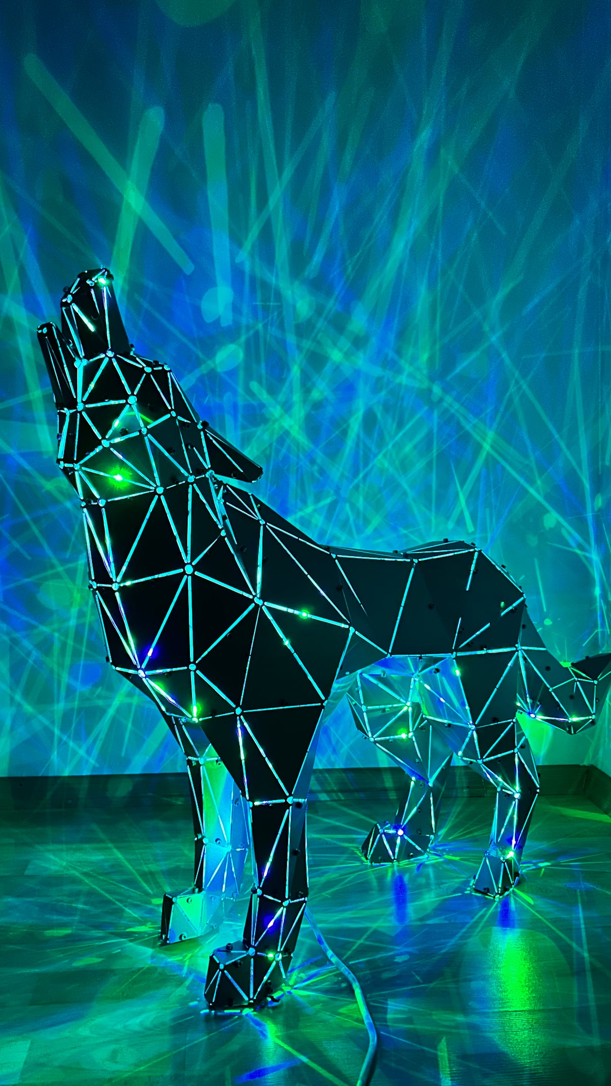 Geometric metal wolf sculpture with integrated LED lights against a neon blue background