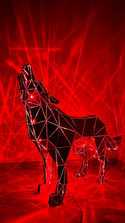 Geometric metal wolf sculpture howling against a red laser light backdrop