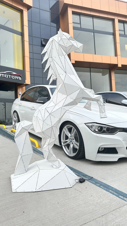 Geometric white metal horse sculpture standing next to a white luxury car.