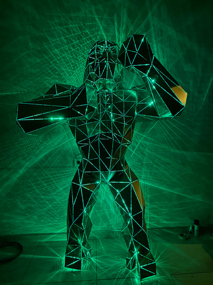 Geometric wireframe gorilla sculpture illuminated by green laser lights