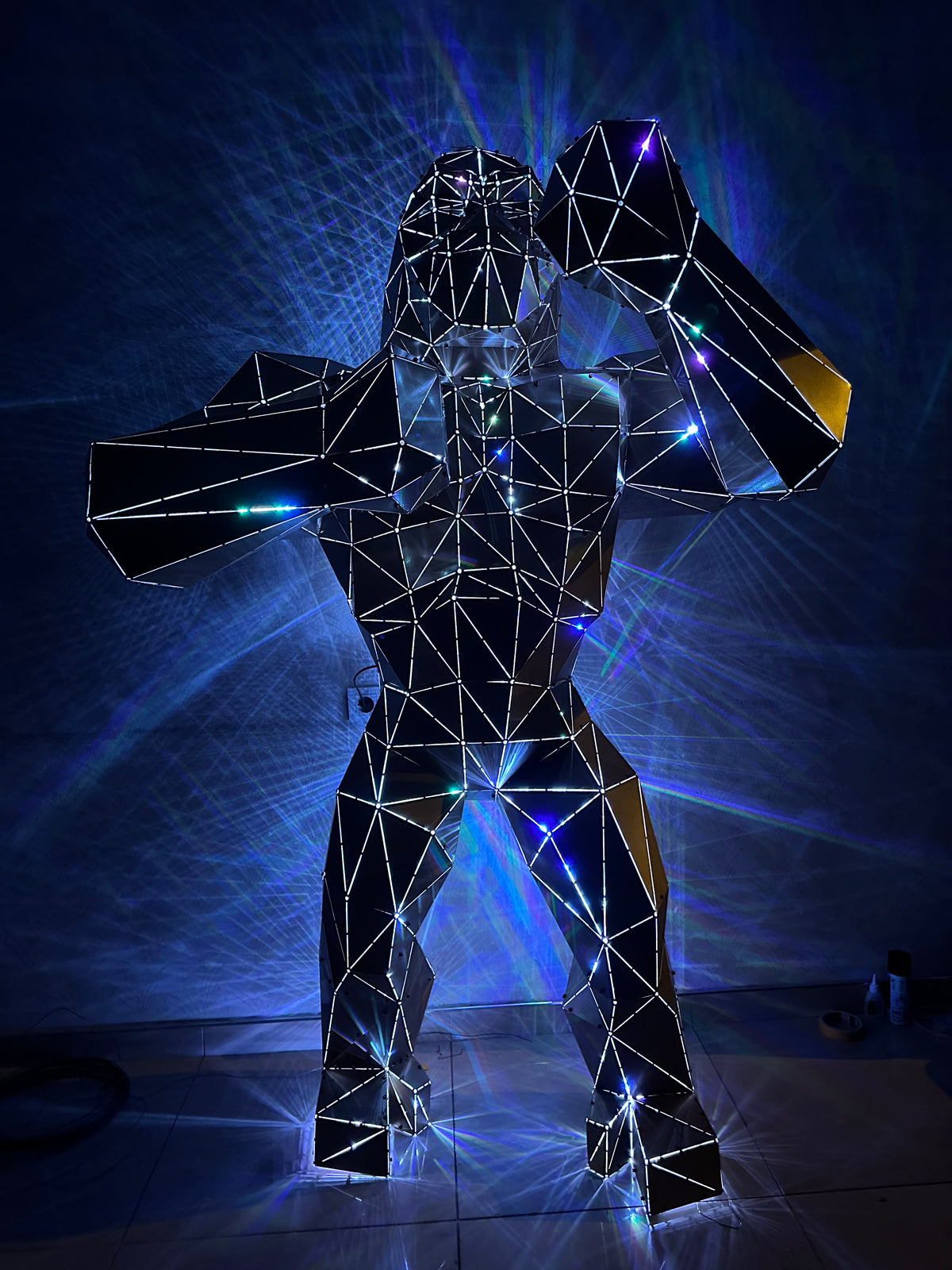 Geometric wireframe metal gorilla sculpture with integrated blue LED lighting