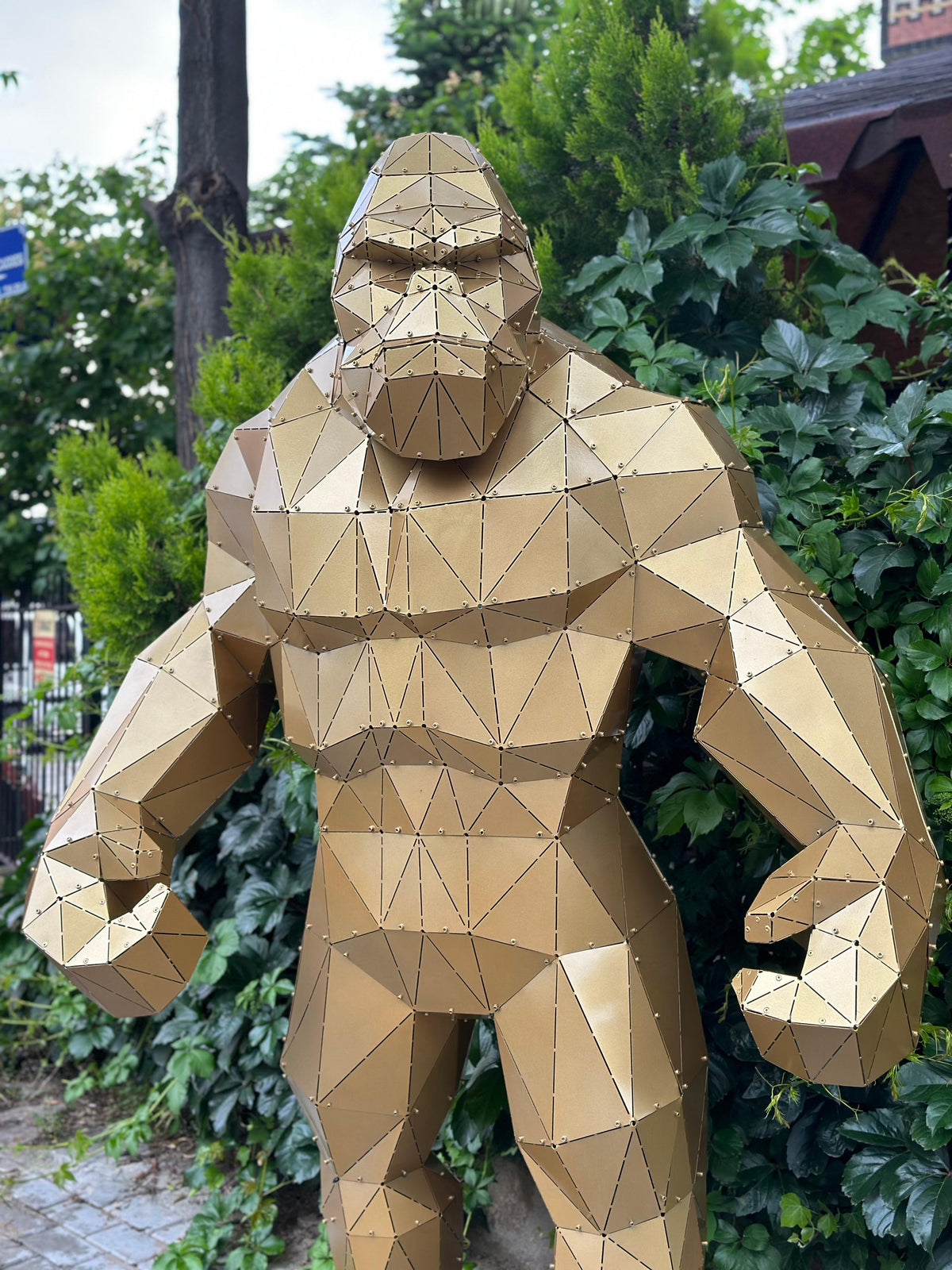 Metart Atelier geometric gold King Kong gorilla metal sculpture in a garden setting