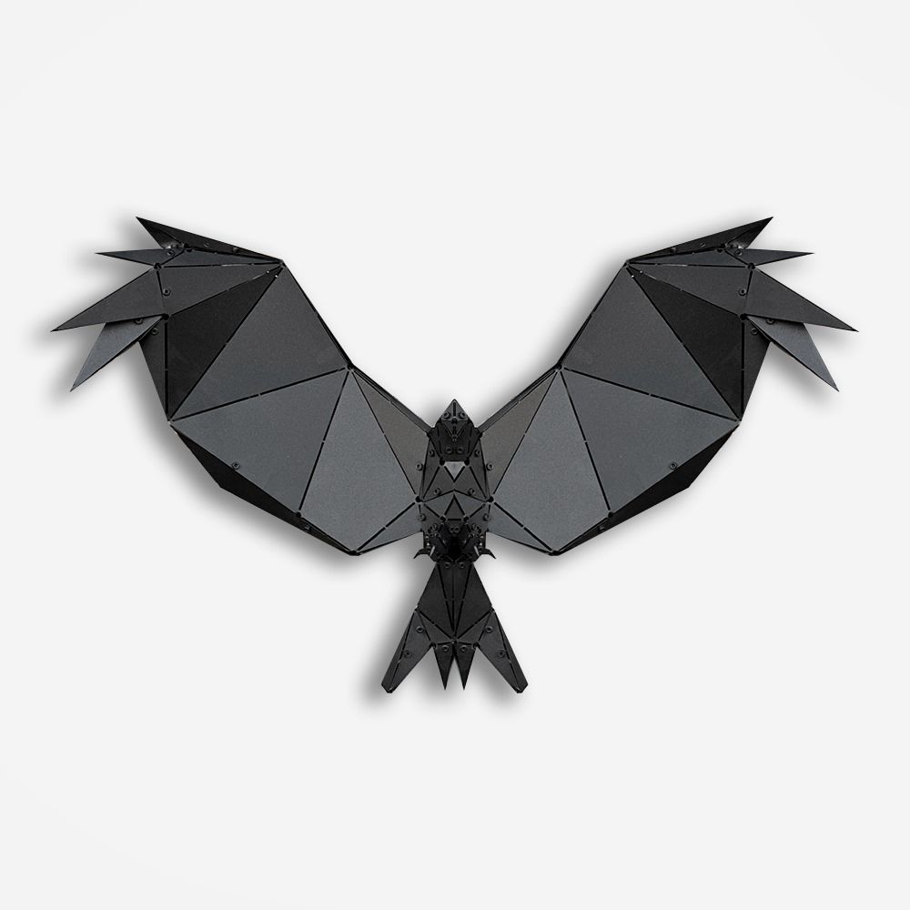 Handcrafted black metal geometric bird sculpture with spread wings on a white background