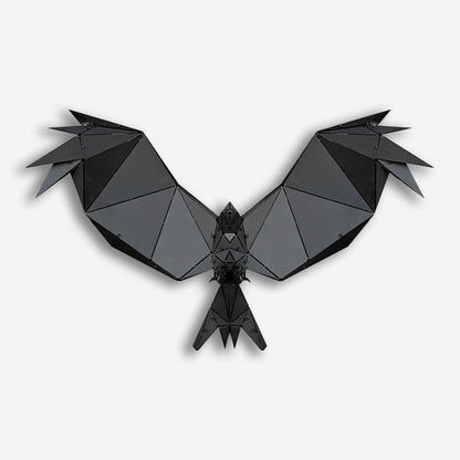 Handcrafted black metal geometric bird sculpture with spread wings on a white background