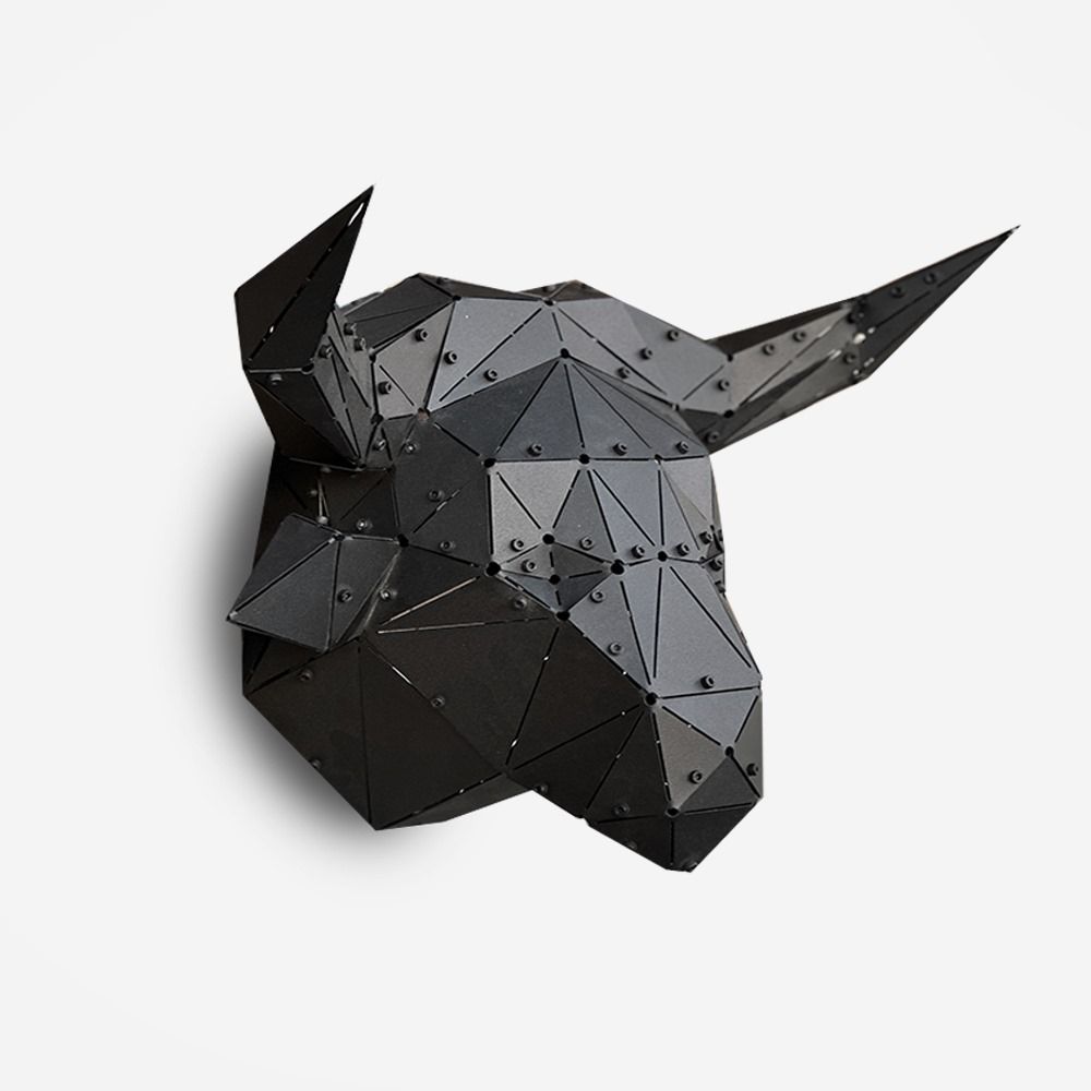 Handcrafted black metal low-poly bull head sculpture on a white background