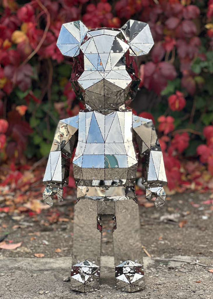 Handcrafted polished mirror-finish metal bear sculpture with geometric facets.