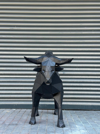 Low-poly black metal bull sculpture standing against a gray ribbed industrial shutter.