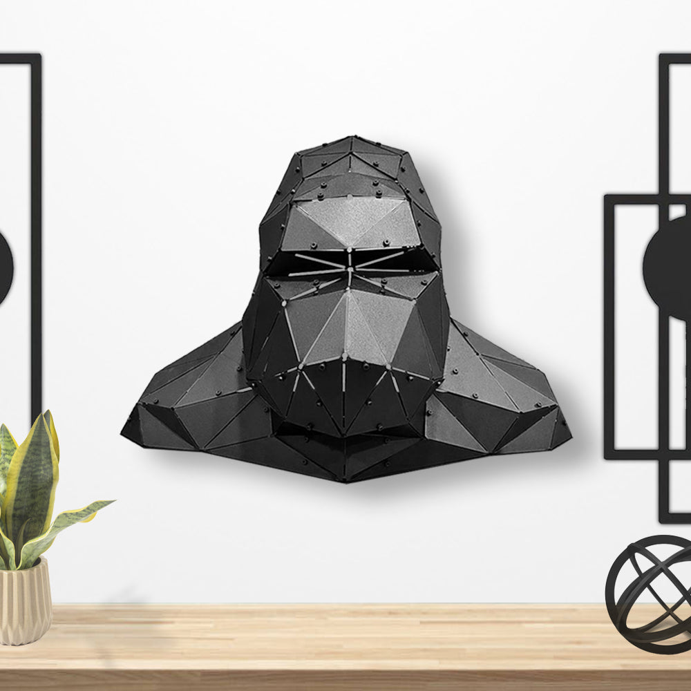 Low-poly black metal gorilla head wall sculpture in a modern interior.