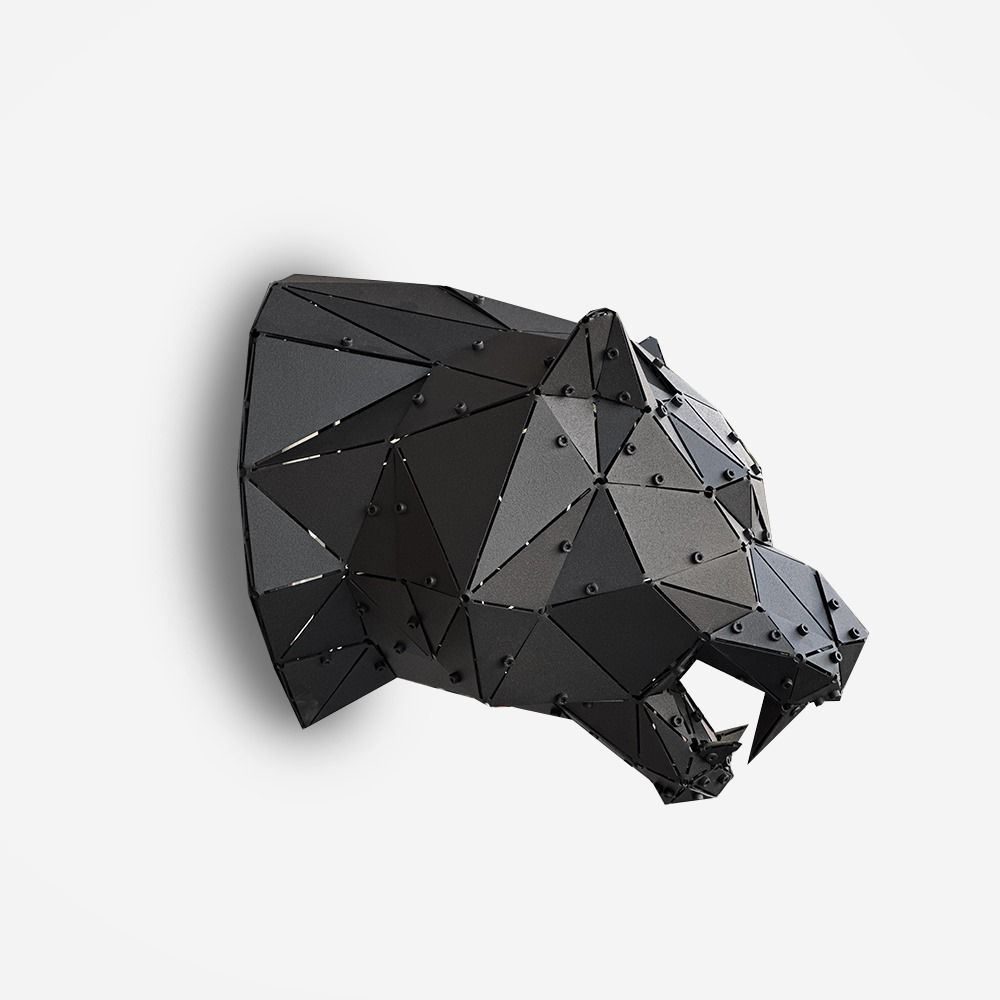 Low-poly black metal tiger head sculpture in side profile on a white background