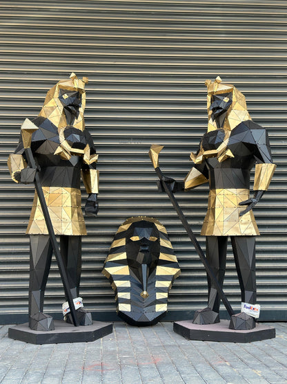 Low-poly gold and black metal Egyptian sculptures of pharaohs and a sphinx head.