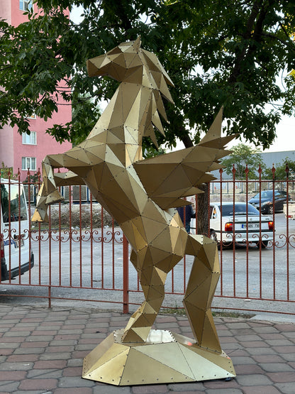 Low-poly gold metal Pegasus sculpture standing outdoors near a residential street.