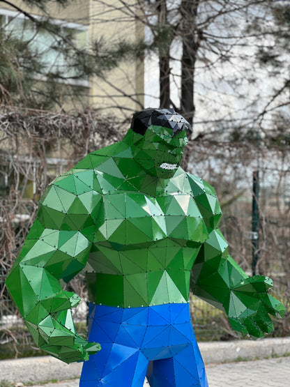 Low-poly green Hulk metal sculpture with blue pants in a geometric handcrafted style