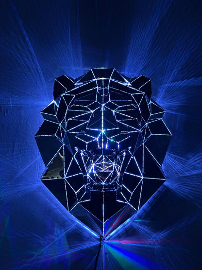 Low-poly metal lion head sculpture illuminated by blue laser light rays
