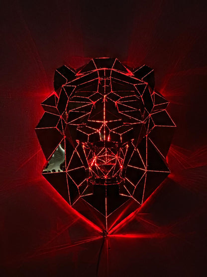 Low poly metal lion head sculpture illuminated with red neon light