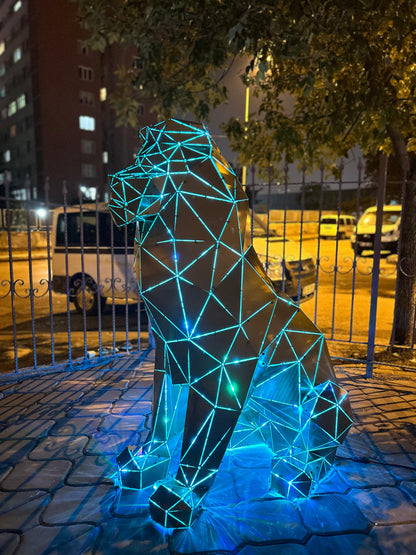 Low-poly metal lion sculpture with blue neon lighting at night