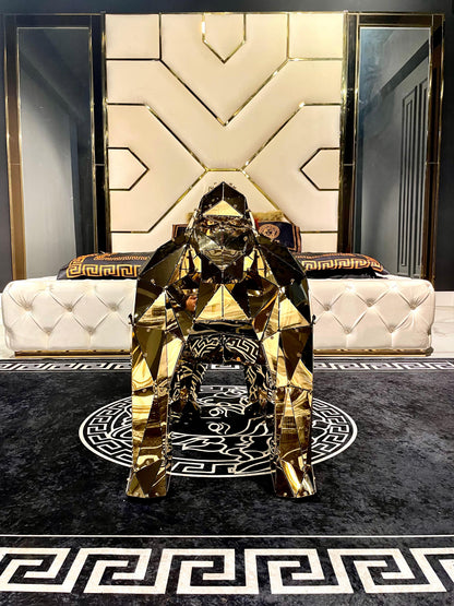 Luxury gold geometric gorilla sculpture in a modern white and gold bedroom