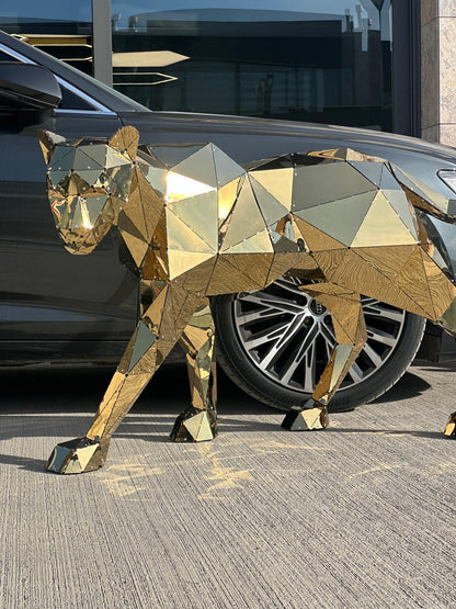 Luxury gold geometric metal panther sculpture walking beside a dark car