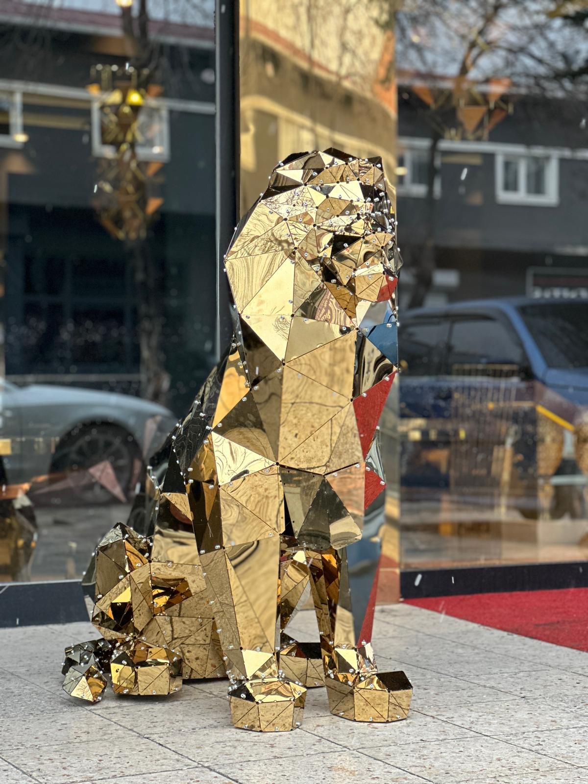 Luxury gold geometric metal sitting lion sculpture with reflective mirrored facets