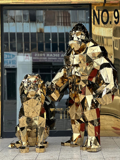 Luxury gold mirrored geometric lion and gorilla sculptures side by side in a storefront