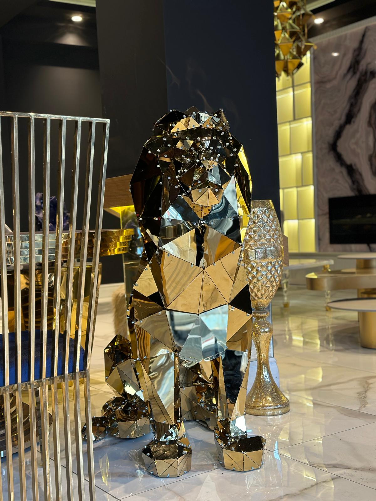 Luxury handcrafted geometric gold metal lion sculpture in a modern interior.