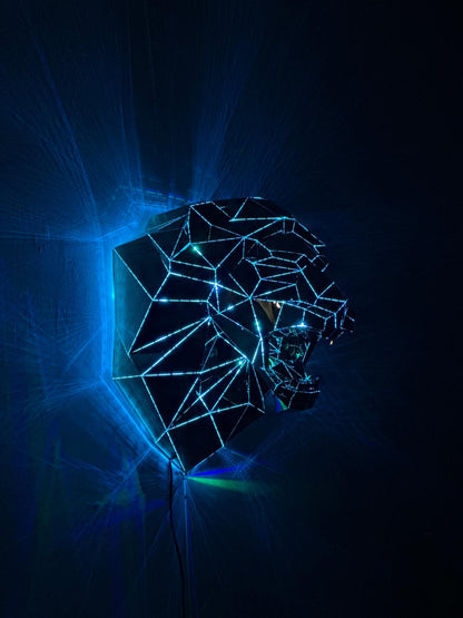 Luxury handcrafted geometric lion head sculpture with blue neon LED lights on a dark background