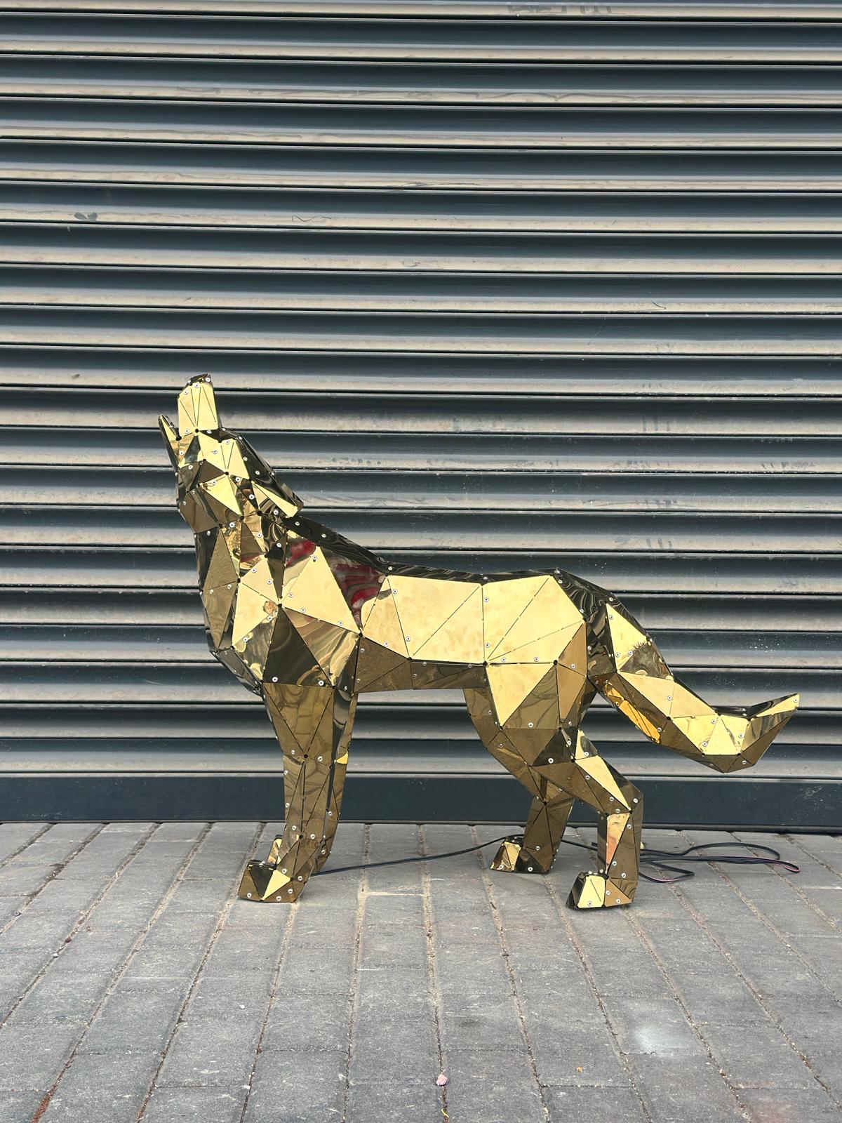 Luxury handcrafted gold metal wolf sculpture with a geometric low-poly design.