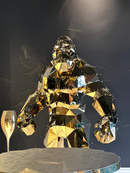 Luxury handcrafted gold mirrored gorilla sculpture with a geometric low-poly design