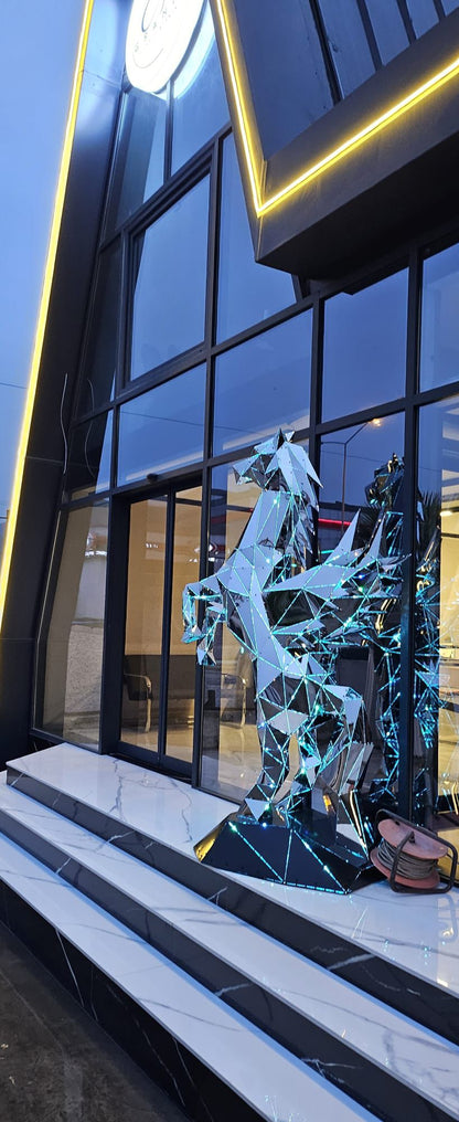 Luxury handcrafted mirrored metal Pegasus winged horse sculpture displayed at a modern storefront