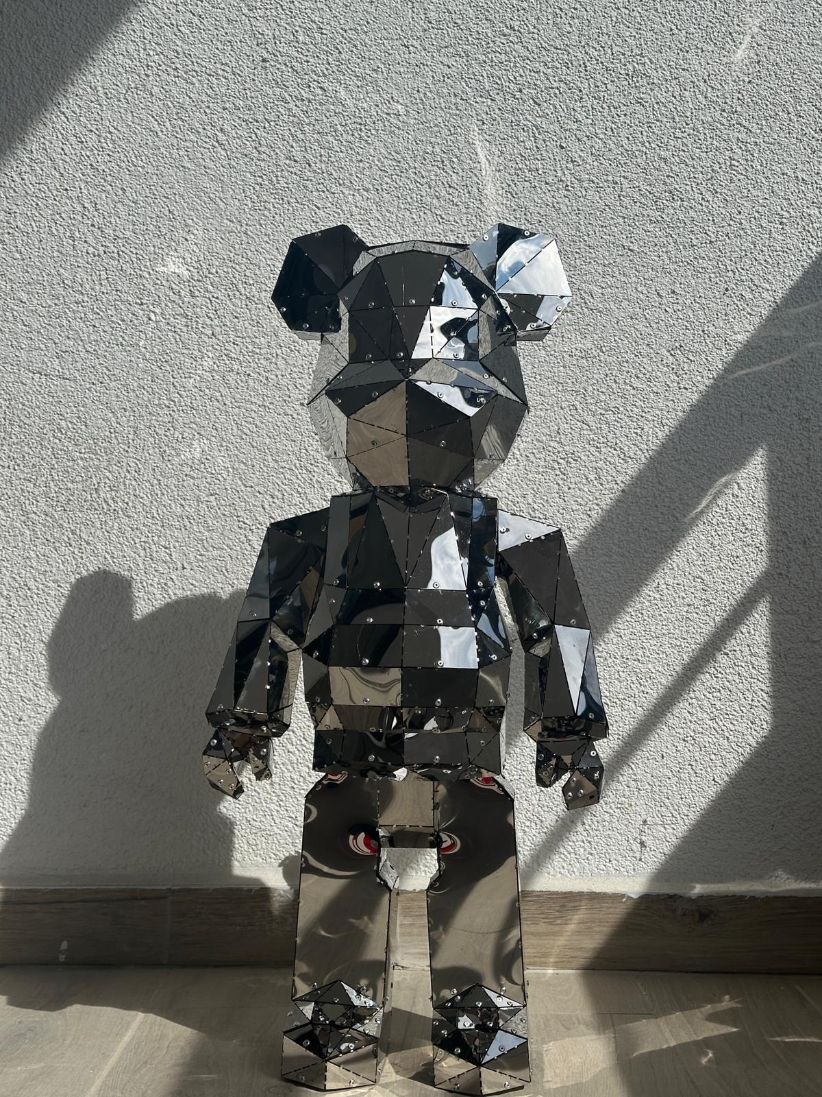 Luxury handcrafted mirrored stainless steel bear sculpture with a faceted geometric design.