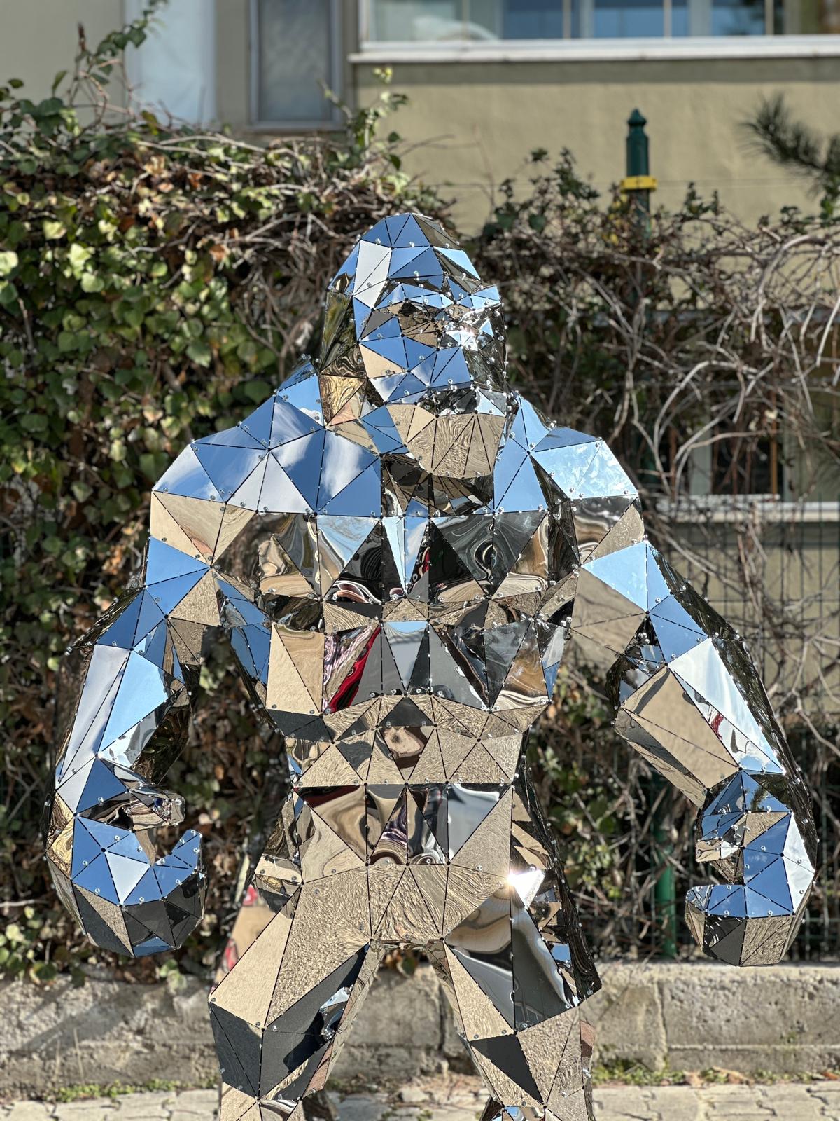 Luxury handcrafted mirrored stainless steel gorilla sculpture with a geometric faceted design