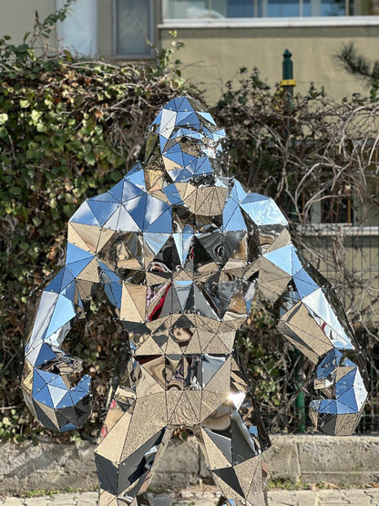 Luxury handcrafted mirrored stainless steel gorilla sculpture with a geometric faceted design