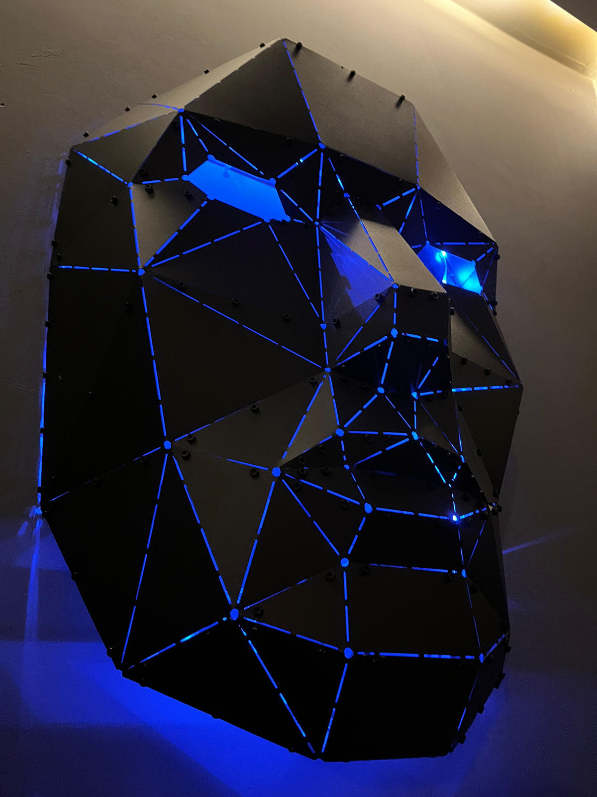 Luxury low-poly metal face sculpture with blue LED backlighting