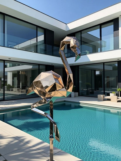 Polished metal geometric bird sculpture beside a luxury villa swimming pool