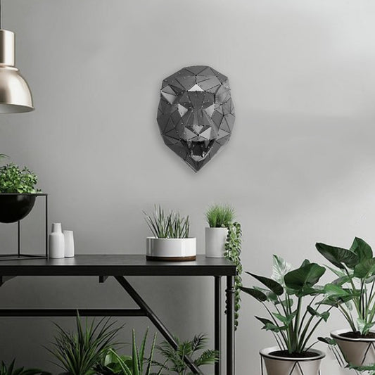 Modern geometric metal lion head sculpture mounted on a minimalist grey wall