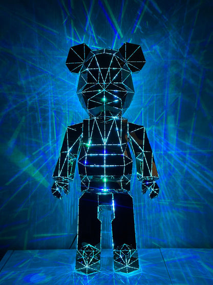 Modern geometric mirrored bear sculpture illuminated by blue laser lights