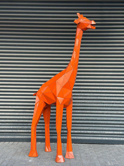 Orange geometric metal giraffe sculpture against a grey corrugated shutter background.