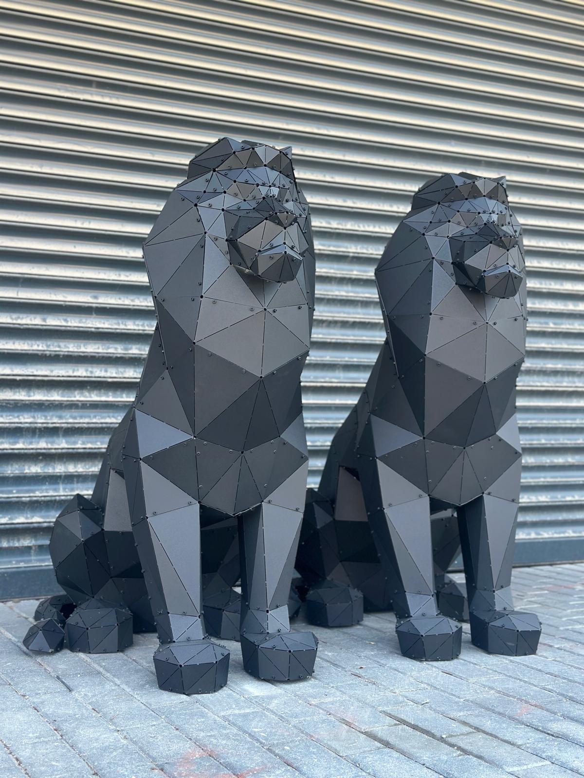 Two luxury black geometric metal lion sculptures against a grey shutter background