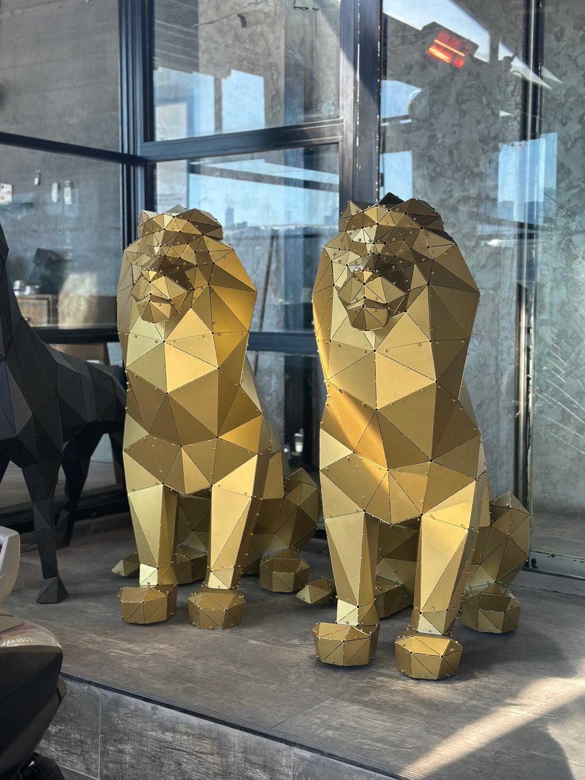 Two luxury gold geometric lion sculptures handcrafted from metal.